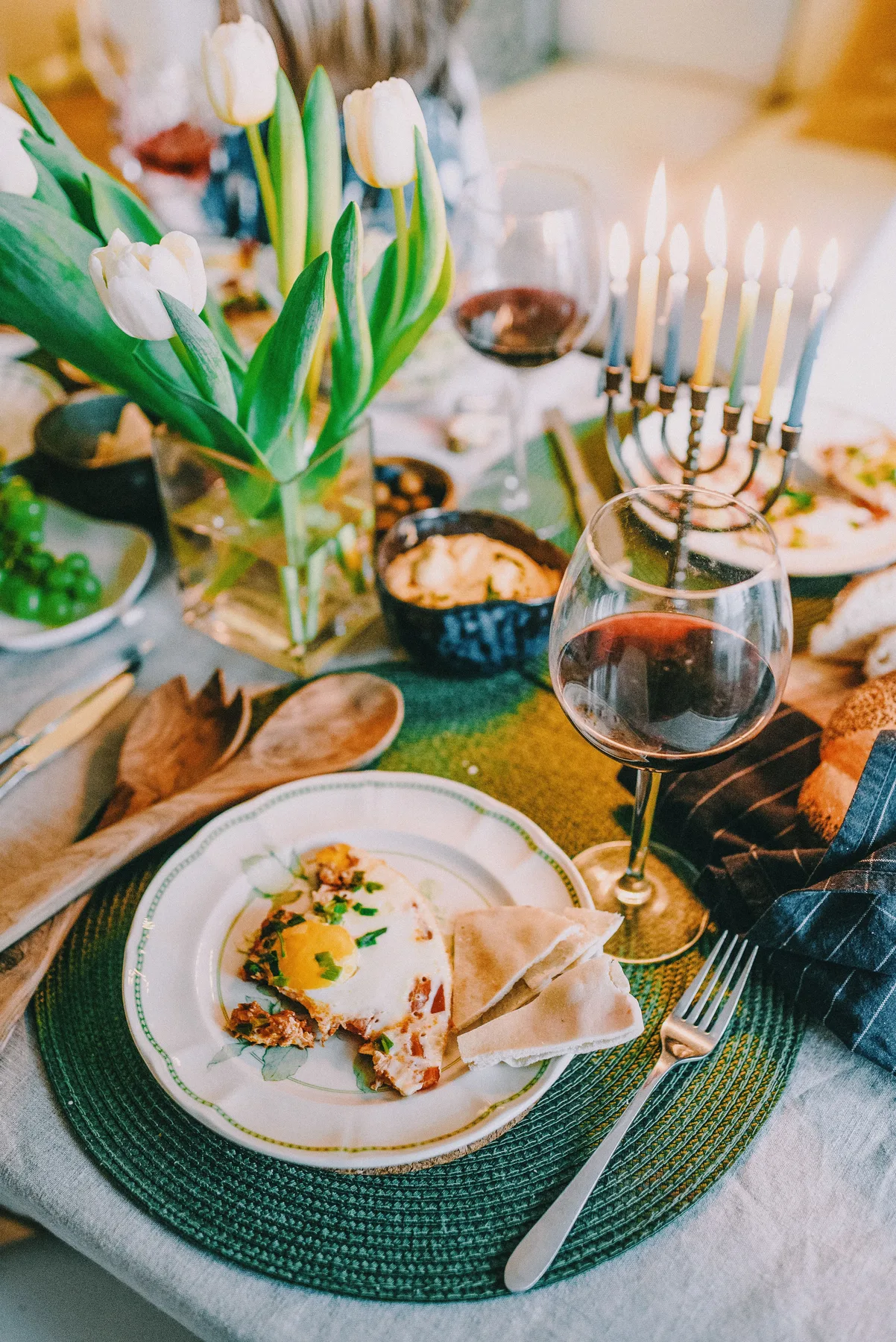 A menorah and flowers set for a Jewish holiday gathering